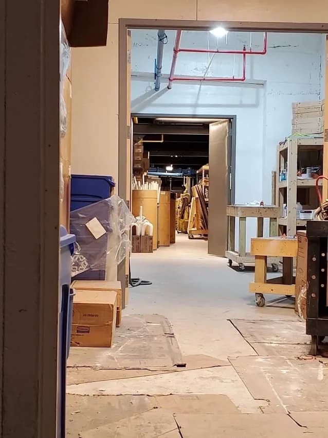 A commercial back-of-house corridor stacked with materials