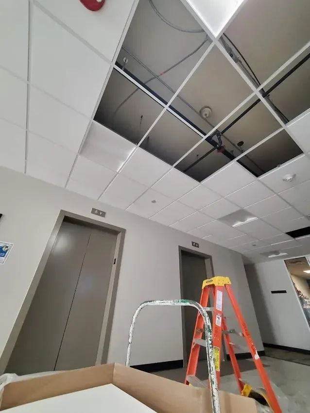Ceiling grid opened up over an elevator lobby