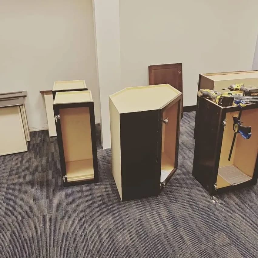 Cabinet boxes staged on the floor before they go in