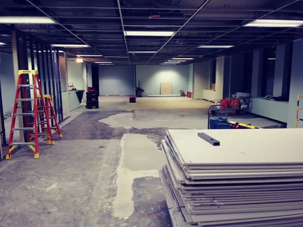 An open office floor with drywall stacked and ready
